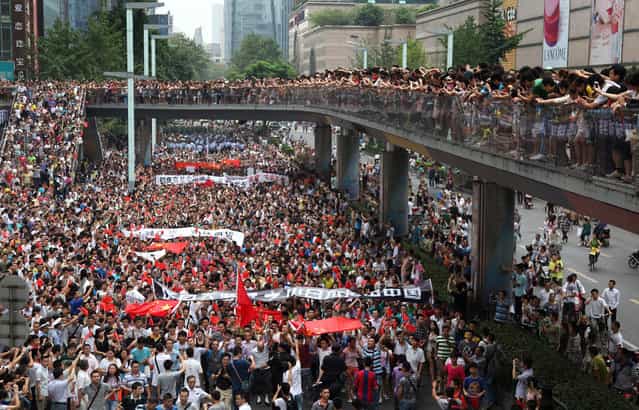 Thousands of Chinese protesters take part in a demonstration in Chengdu, Sichuan province against Japan's claim of the Diaoyu islands, as they are known in Chinese, or Senkaku islands in Japanese, on August 19, 2012. (Photo by STR/AFP)
