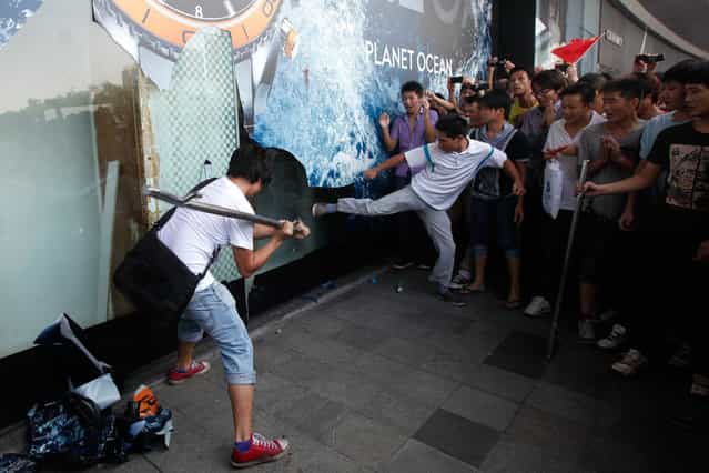 Demonstrators damage a window on a Japanese Seibu department store during a protest against Japan's decision to purchase the Diaoyu/Senkaku Islands, in Shenzhen, south China's Guangdong province, on September 16, 2012. (Photo by Tyrone Siu/Reuters)