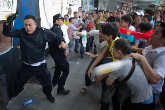 Anti-Japanese protesters are confronted by police as they demonstrate over the disputed Diaoyu/Senkaku Islands, on September 16, 2012 in Shenzhen, China. (Photo by Lam Yik Fei)