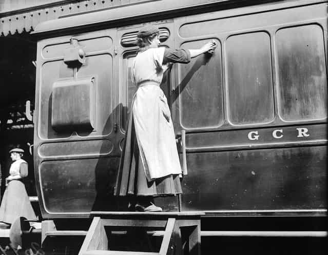 A member of the Women Porters At Marylebone Station Group giving a Great Central Railways carriage a thorough clean, 1914. (Photo by Topical Press Agency)
