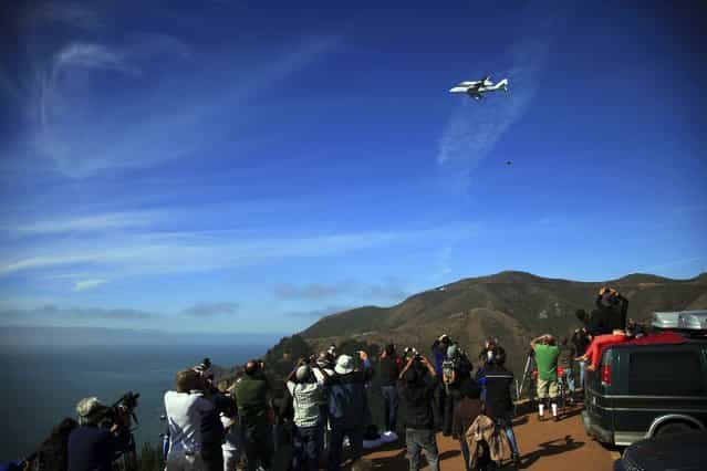 Onlookers at the Golden Gate National Recreation Area, near the Golden Gate Bridge in San Francisco, watch Endeavour pass overhead. (Photo by Jim Wilson/The New York Times)