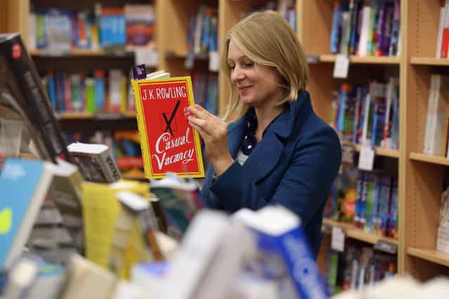 A woman at Foyles bookshop looks at a copy of J. K. Rowling's latest novel 'The Casual Vacancy' which has gone on sale today starting at 8:00 am on September 27, 2012 in London, England. 'The Casual Vacancy' is J. K. Rowling's first book aimed at an adult readership and is centered on a parish council election in a small West Country town. (Photo by Oli Scarff)