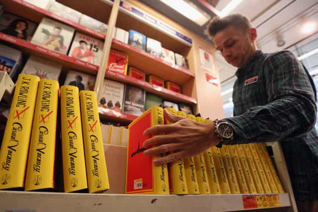 An employee at Foyles bookshop arranges copies of J. K. Rowling's latest novel 'The Casual Vacancy' which has gone on sale today starting at 8:00 am on September 27, 2012 in London, England. 'The Casual Vacancy' is J. K. Rowling's first book aimed at an adult readership and is centered on a parish council election in a small West Country town. (Photo by Oli Scarff)