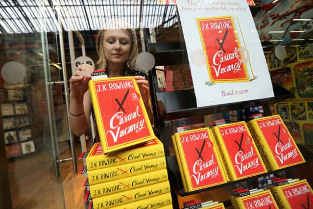 A woman stands behind copies of J. K. Rowling's latest novel 'The Casual Vacancy' which has gone on sale today starting at 8:00 am on September 27, 2012 in London, England. 'The Casual Vacancy' is J. K. Rowling's first book aimed at an adult readership and is centered on a parish council election in a small West Country town. (Photo by Oli Scarff)