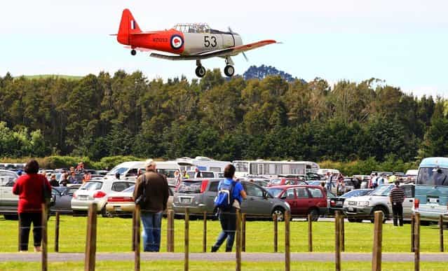 The Roaring 40's Harvard display team perform during an airshow commemorating the rebuild of Havilland Mosquito KA 114, on September 29, 2012 in Ardmore, New Zealand. The plane was restored by Warbird Restorations at Ardmore Aerodrome and is the only flying Mosquito in the world. (Photo by Simon Watts)