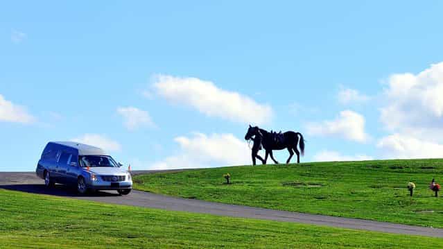 Trooper Mike Funk follows a hearse leading a riderless horse through St. Mary's Cemetery during the funeral for Pennsylvania State Trooper Blake Coble, who was killed in a western Pennsylvania vehicle crash last week, in Chippewa Township, Pennsylvania, on October 9, 2012. (Photo by Lucy Schaly/Beaver County Times)