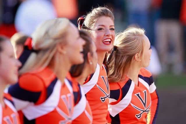 Cheerleaders for the Virginia Cavaliers sing on the sidelines against the Maryland Terrapins at Scott Stadium on October 13, 2012 in Charlottesville, Virginia. (Photo by Geoff Burke)