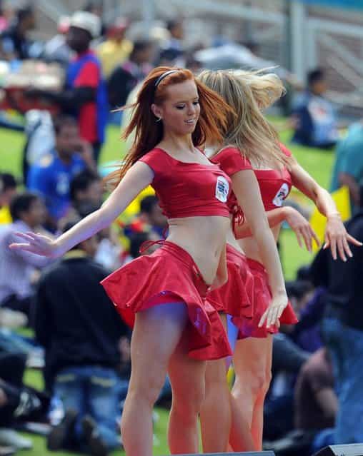 Cheerleaders perform during a Group B match of the Champions League T20 (CLT20) between the Chennal Super Kings and the Sydney Sixers at the Wanderers Stadium in Johannesburg on October 14, 2012. (Photo by Alexander Joe/AFP Photo)