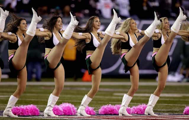 New York Jets cheerleaders use pink pom-poms as they perform before the Monday night game against the Houston Texans in East Rutherford, N.J. (Photo by Kathy Willens/Associated Press)