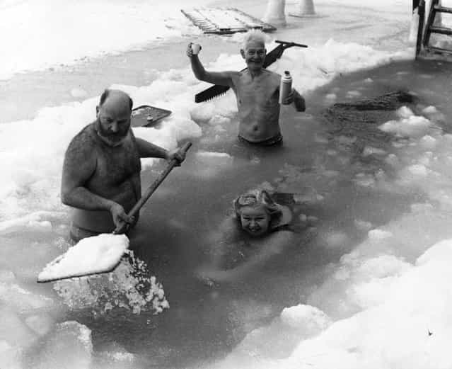 People swimming in a frozen lake in Scandinavia, February 1972. (Photo by Fox Photos)