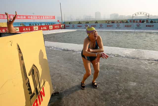 Winter swimmers performer at a pool carved out of the frozen Songhua river during the 22nd Harbin International Ice and Snow Festival on January 11, 2006 in Harbin, Heilongjiang Province in north China. Harbin is one of China's coldest cities and each winter hosts an ice festival, with famous buildings and landmarks from around the world recreated in ice. (Photo by Cancan Chu)