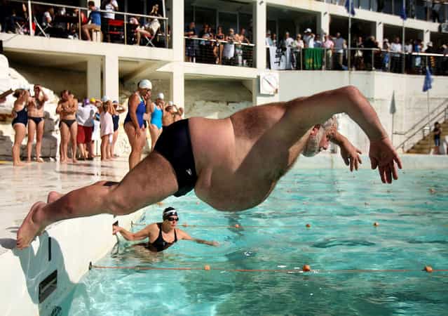 A member of Icebergs Swimming Club dives in to the pool during the opening day of the winter swimming season at Bondi Icebergs on May 4, 2008 in Sydney, Australia. Bondi Icebergs, which began in 1929, is known as the [Home of Winter Swimming], and has in excess of 700 dedicated swimmers competing in handicapped races during the winter season, lasting from the first weekend in May to the last weekend in September. The first Sunday in May each year is the official opening of the winter swimming season and members jump in to the pool with blocks of ice. (Photo by Ezra Shaw)