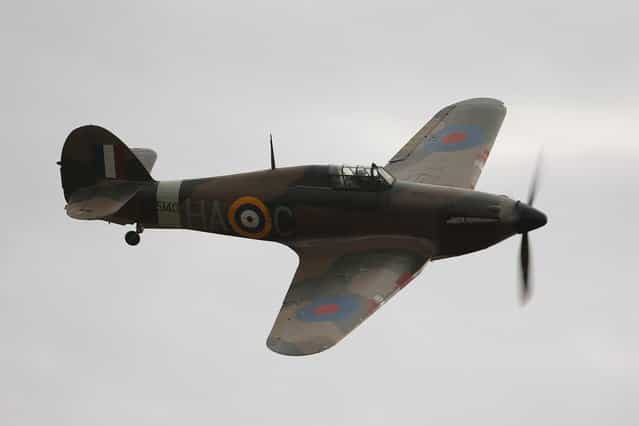A Hawker Hurricane Mk XIIa 5711 (G-HURI) fighter aircraft performs an aerobatic display at the IWM Duxford on October 18, 2012 in Duxford, England. The aeroplane, similar to those that defended British shores during the Battle of Britain in World War II, is due to be auctioned by Bonhams in their sale of [Collectors' Motor Cars and Automobilia] at Mercedes-Benz World Brooklands on December 3, 2012. The plane was built in 1942 and joined the Royal Canadian Air Force the following year, where it remained for the duration of the war, it is expected to fetch up to 17 million GBP. (Photo by Oli Scarff)