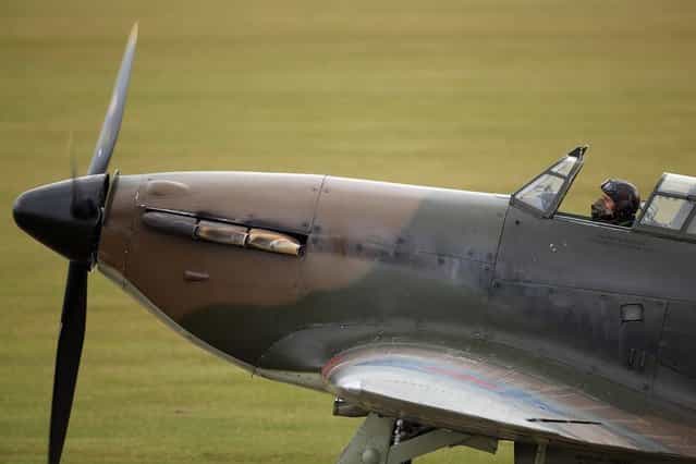 A Hawker Hurricane Mk XIIa 5711 (G-HURI) fighter aircraft prepares to perform an aerobatic display at the IWM Duxford on October 18, 2012 in Duxford, England. The aeroplane, similar to those that defended British shores during the Battle of Britain in World War II, is due to be auctioned by Bonhams in their sale of [Collectors' Motor Cars and Automobilia] at Mercedes-Benz World Brooklands on December 3, 2012. The plane was built in 1942 and joined the Royal Canadian Air Force the following year, where it remained for the duration of the war, it is expected to fetch up to 17 million GBP. (Photo by Oli Scarff)