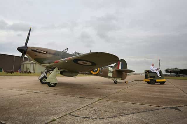 A Hawker Hurricane Mk XIIa 5711 (G-HURI) fighter aircraft prepares to perform an aerobatic display at the IWM Duxford on October 18, 2012 in Duxford, England. The aeroplane, similar to those that defended British shores during the Battle of Britain in World War II, is due to be auctioned by Bonhams in their sale of [Collectors' Motor Cars and Automobilia] at Mercedes-Benz World Brooklands on December 3, 2012. The plane was built in 1942 and joined the Royal Canadian Air Force the following year, where it remained for the duration of the war, it is expected to fetch up to 17 million GBP. (Photo by Oli Scarff)