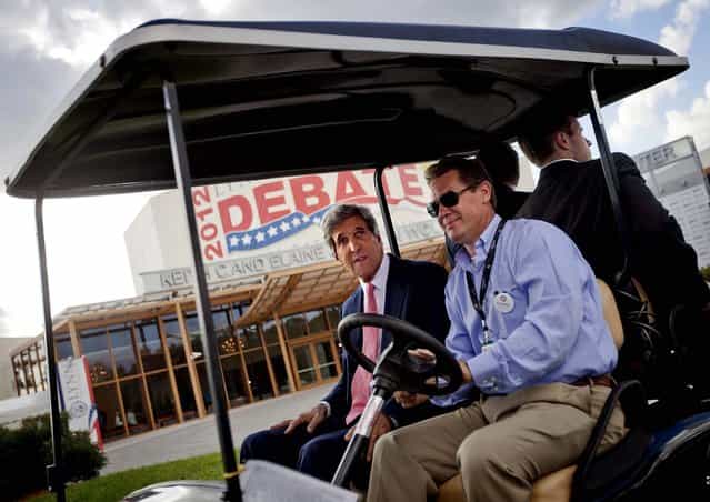 Sen. John Kerry, D-Mass rides in a golf cart after giving an interview in front of the debate hall Monday afternoon. (Photo by David Goldman/Associated Press)