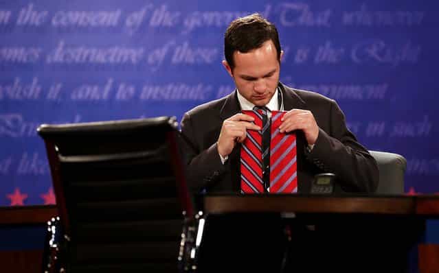 A Romney assistant tests ties under the stage lighting for television before the debate; Romney wound up wearing the tie on the right. (Photo by Richard Graulich/The Palm Beach Post)