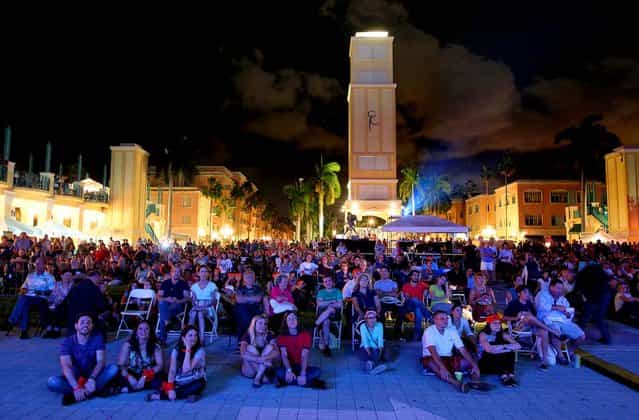 People watch the debate on a large screen at Mizner Park in Boca Raton. (Photo by Allen Eyestone/The Palm Beach Post)