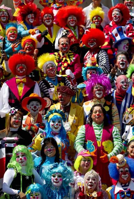 Clowns pose for the official photo at the XVII th Clown Convention in Mexico City. (Photo by Eduardo Verdugo/Associated Press)