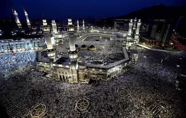 Muslim pilgrims circle the Kaaba as people pray inside and outside the Grand Mosque in Mecca, Saudi Arabia October 22, 2012. The annual Islamic pilgrimage draws two to three million visitors each year, making it the largest yearly gathering of people in the world. (Photo by Hassan Ammar/Associated Press)