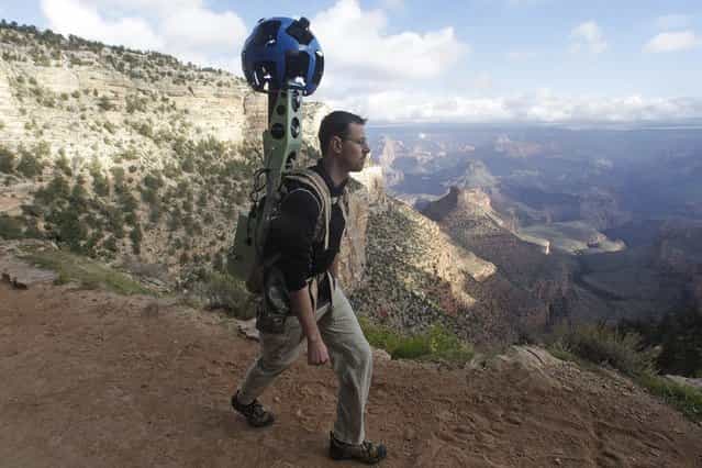 In this October 22, 2012, photo, Google product manager Ryan Falor walks with the Trekker during a demonstration for the media along the Bright Angel Trail at the South Rim of the Grand Canyon National Park in Arizona. The search engine giant is using the nearly 40-pound, backpack-sized camera unit to showcase the Grand Canyon's most popular hiking trails on the South Rim and other off-road sites. It's about 4 feet in height when set on the ground, and when worn, the camera system extends 2 feet above the operator's shoulders. (Photo by Rick Bowmer/AP Photo)