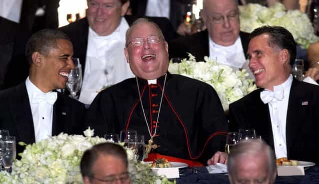 President Barack Obama and Republican presidential candidate, former Massachusetts Gov. Mitt Romney laugh with Cardinal Timothy Dolan during the Archdiocese of New York's 67th Annual Alfred. E. Smith Memorial Foundation Dinner, at the Waldorf Astoria Hotel in New York October 18, 2012. The white-tie gala has been a required stop for politicians since the end of World War II. In keeping with tradition, candidates prepare humorous fare for the fundraising event organized by the Catholic Archdiocese of New York for the benefit of needy children. (Photo by Carolyn Kaster/Associated Press)