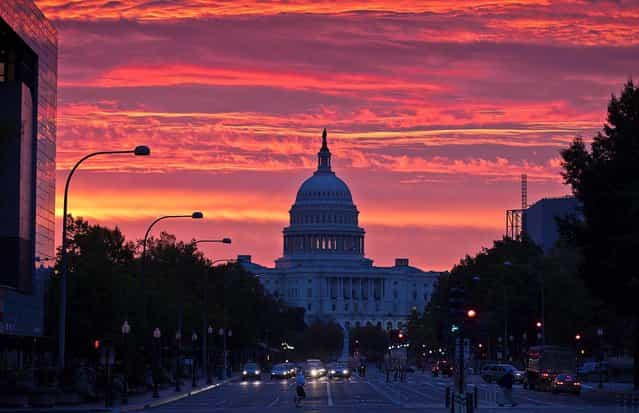 The sun rises over the Capitol in Washington, D.C., October 15, 2012. (Photo by J. Scott Applewhite/Associated Press)