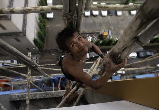 A man climbs a scaffolding at a construction site in Yangon, Myanmar October 16, 2012. (Photo by Soe Zeya Tun/Reuters)