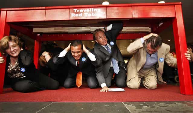 Dr. Lucile Jones with the U.S. Geological Survey, Los Angeles Mayor Antonio Villaraigosa, Paul Schulz CEO of the American Red Cross and Richard Katzr dropped under the red table to [drop, cover, and hold on] during the Great California ShakeOut earthquake drill at Union Station October 18, 2012. (Photo by Al Seib/Los Angeles Times)