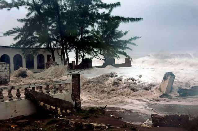 Waves brought by Hurricane Sandy crash on a house in the Caribbean Terrace neighborhood in eastern Kingston, Jamaica. Hurricane Sandy pounded Jamaica with heavy rain as it headed for landfall near the country's most populous city on Wednesday. (Photo by Collin Reid/Associated Press)