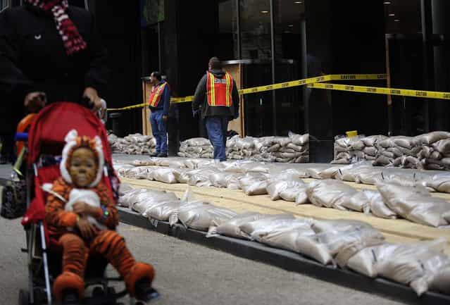 Sandbags are placed in front of No. 2 Broadway in Manhattan's Battery Park on Sunday. (Photo by Louis Lanzano/Associated Press)