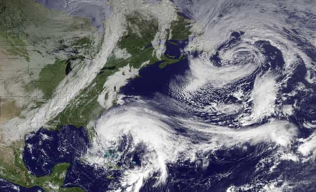 In this image taken by NOAA's GOES East at 2:45 GMT on Friday, Hurricane Sandy is seen in the center bottom. It is expected to move north, just off the eastern seaboard. When Hurricane Sandy becomes a hybrid weather monster some call [Frankenstorm] it will smack the East Coast harder and wider than last year's damaging Irene, forecasters said Friday. (Photo by NOAA)