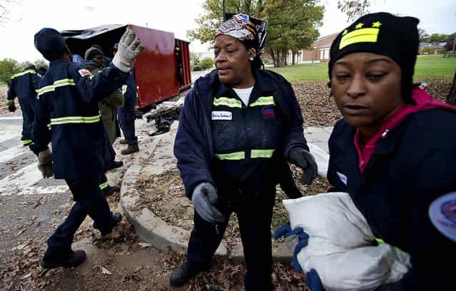 District of Columbia Department of Public Works workers pass out free sandbags to DC residents in Washington on Sunday. (Photo by Manuel Balce Ceneta/Associated Press)