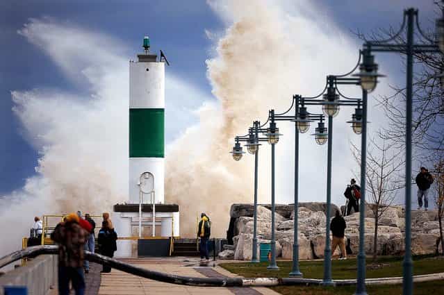 A large crowd is drawn to the Lake Michigan shoreline in Kenosha, Wis. to watch big waves caused by winds from superstorm Sandy. (Photo by Bill Siel/The Kenosha News)