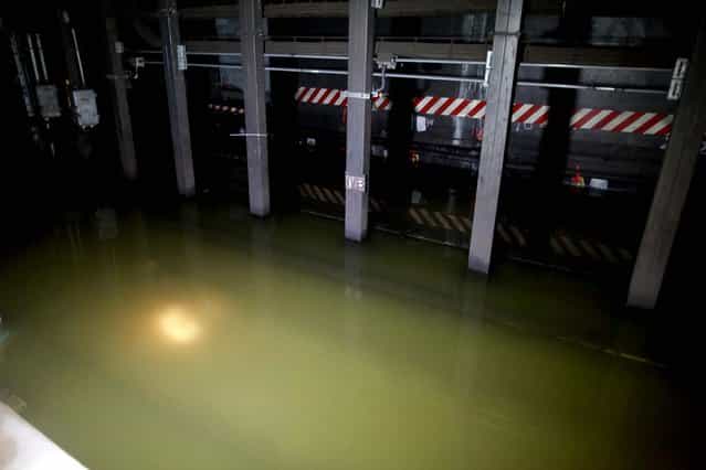 Floodwaters are pumped out from train tracks at the South Ferry subway station in Manhattan. (Photo by Hiroko Masuike/The New York Times)