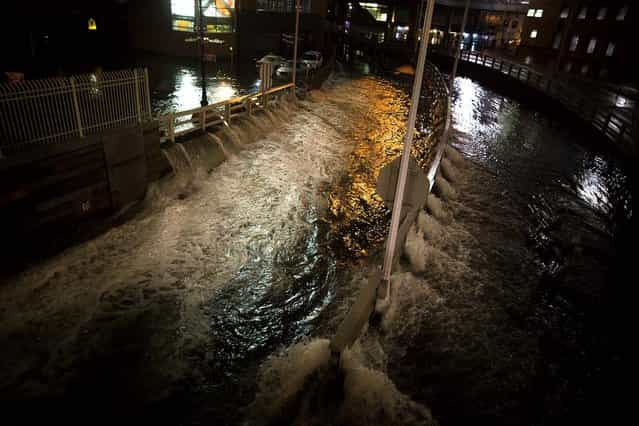 Seawater floods the entrance to the Brooklyn Battery Tunnel in New York. (Photo by John Minchillo/Associated Press)