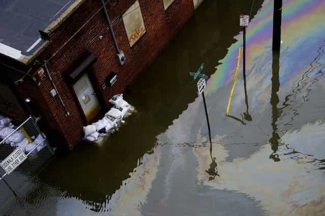 A street and business are flooded in Hoboken, NJ. (Photo by Charles Sykes/Associated Press)