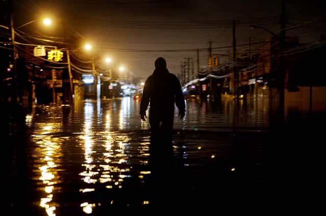 A man wades through flood waters on Hylan Boulevard in Staten Island. (Photo by Victor J. Blue/Bloomberg)