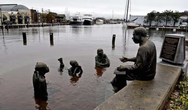 The Kunta Kinte-Alex Haley Memorial sits in flood waters in downtown Annapolis, Maryland. (Photo by Susan Walsh/Associated Press)