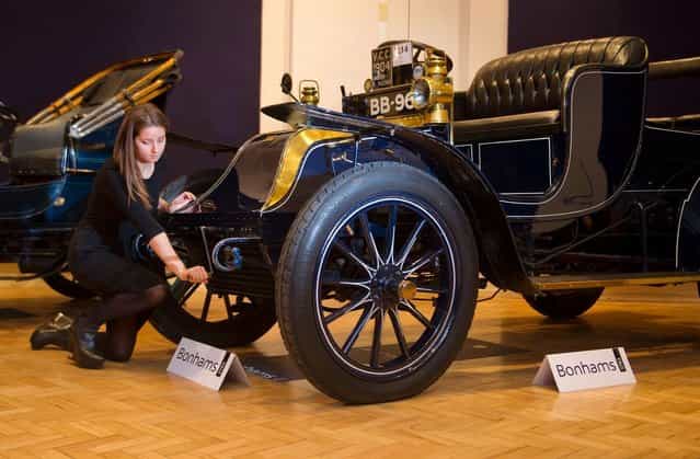 Bonhams employee, Sarah Gubbins pictured with a 1904 Wilson-Pilcher, thought to be the oldest surviving example of its type on November 1, 2012 in London, England. The Car is part of a Veteran Car Sale at Bonhams and is valued at around 220,000 pounds (Photo by Bethany Clarke)