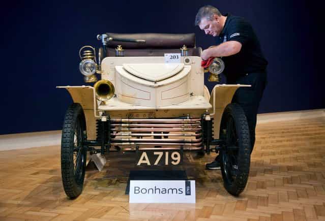 Bonhams employee Craig Binns polishes a, 1903 two seater moter car, the world oldest surviving Vauxhall, on November 1, 2012 in London, England. The Car is part of a Veteran Car Sale at Bonhams and is valued at around 80,000 pounds (Photo by Bethany Clarke)