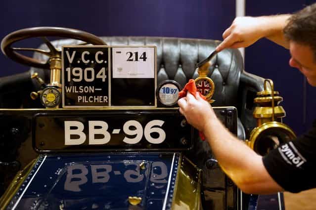 Bonhams employee Craig Binns polishes a 1904 Wilson-Pilcher, thought to be the oldest surviving example of its type on November 1, 2012 in London, England. The Car is part of a Veteran Car Sale at Bonhams and is valued at around 220,000 pounds (Photo by Bethany Clarke)