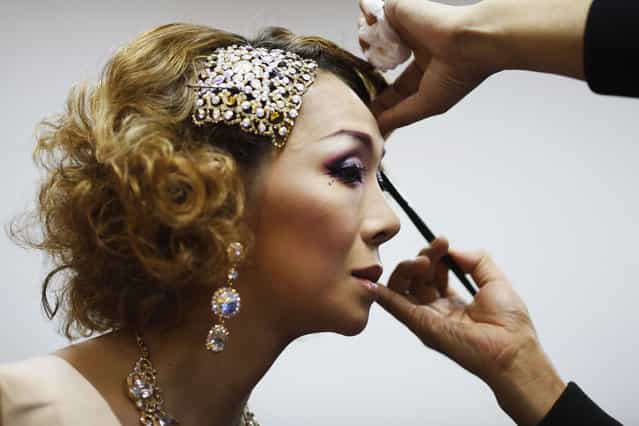 Tukishima Beni, a contestant from Japan, gets her make-up done before the start of the final night of Miss International Queen 2012 transgender/transsexual beauty pageant in Pattaya November 2, 2012. Some 21 contestants from 15 countries, all of them born male, compete in the week-long event for the crown of Miss International Queen 2012