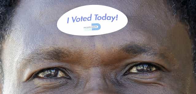 Jean Robert Soutien displays on his forehead the sticker he received after voting during the U.S. presidential election in North Miami Beach, Florida November 6, 2012. (Photo by Andrew Innerarity/Reuters)