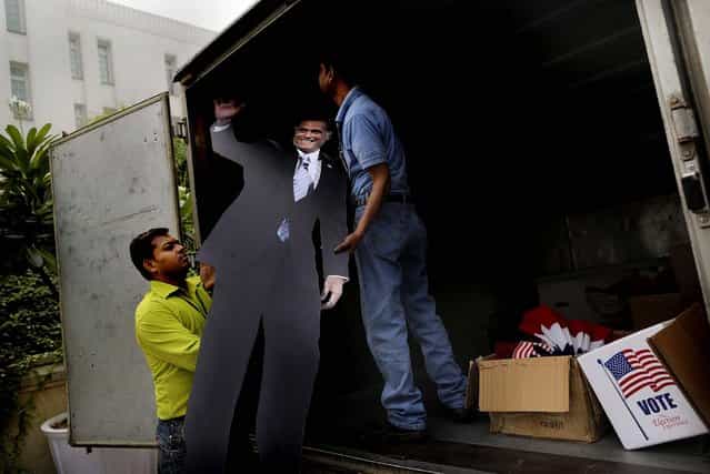 Workers from the U.S. embassy load a cardboard cutout of Republican candidate Mitt Romney into a truck after an event organized by the embassy to mark the U.S. elections, at the landmark Imperial Hotel in New Delhi, India on November 7, 2012, (Photo by Kevin Frayer/Associated Press)