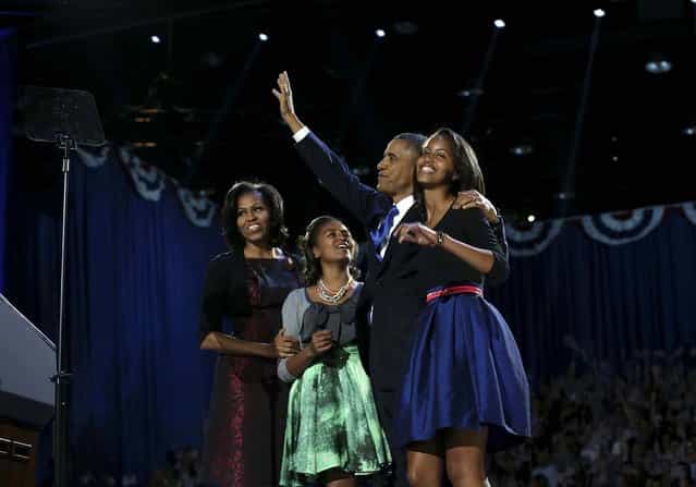 President Barack Obama with his family onstage during his election night event at the McCormick Place Lakeside Center in Chicago, following Election Day, early Wednesday morning, November 7, 2012. President Barack Obama has been elected to a second term. From left: Michelle Obama, Sasha Obama Barack Obama and Malia Obama. (Photo by Doug Mills/The New York Times)