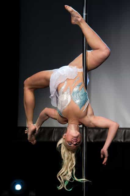 A competitor participates at the World Pole Dancing Championship 2012 held at the Volkshaus on November 10, 2012 in Zurich, Switzerland. The public's perception of pole dancing has recently changed to become a popular sport combining physical strength, technique and choreography. (Photo by Harold Cunningham)