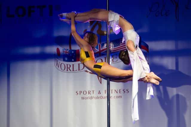 Competitors participate at the World Pole Dancing Championship 2012 held at the Volkshaus on November 10, 2012 in Zurich, Switzerland. The public's perception of pole dancing has recently changed to become a popular sport combining physical strength, technique and choreography. (Photo by Harold Cunningham)
