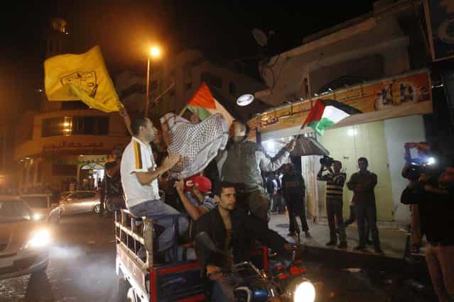 Palestinians celebrate the cease-fire agreement between Israel and Hamas in Gaza City, Wednesday, November 21, 2012. Israel and the Hamas militant group agreed to a ceasefire Wednesday to end eight days of the fiercest fighting in nearly four years, promising to halt attacks on each other and ease an Israeli blockade constricting the Gaza Strip. (Photo by Adel Hana/AP)