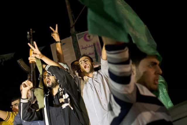 Palestinians celebrate the announcement of a cease-fire between Hamas and Israel in Gaza City, Wednesday, November 21, 2012. Israel and the Hamas militant group agreed to a cease-fire Wednesday to end eight days of the fiercest fighting in nearly four years, promising to halt attacks on each other and ease an Israeli blockade constricting the Gaza Strip. (Photo by Adel Hana/AP)